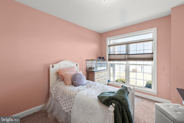 carpeted bedroom featuring baseboards