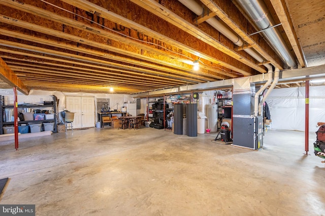 unfinished below grade area featuring heating unit and water heater