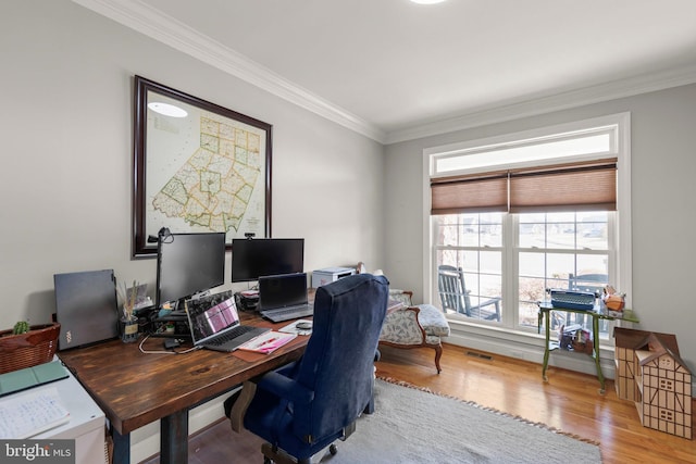 office with visible vents, crown molding, and wood finished floors