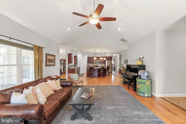 living area featuring visible vents, recessed lighting, light wood-style floors, baseboards, and ceiling fan