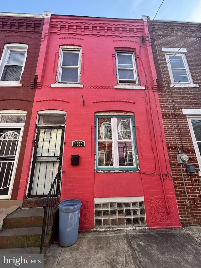 townhome / multi-family property featuring entry steps and brick siding