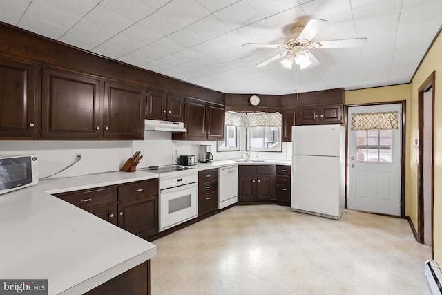 kitchen with white appliances, a baseboard radiator, ceiling fan, light countertops, and under cabinet range hood