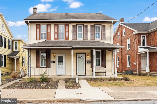 view of front of house with central AC unit and a porch