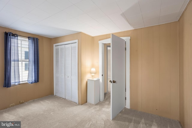 unfurnished bedroom with a closet and carpet floors