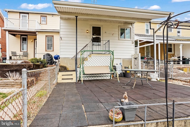 view of front of home featuring a patio area and fence