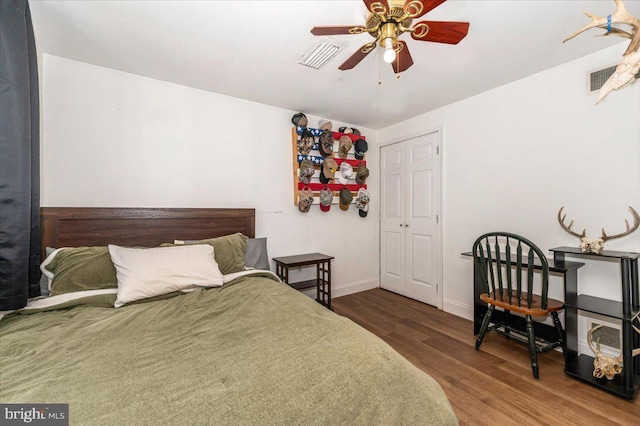 bedroom with baseboards, ceiling fan, and wood finished floors