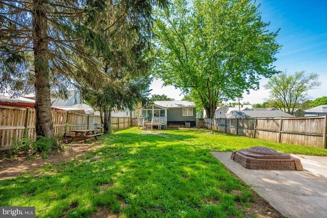 view of yard with a fenced backyard and an outdoor fire pit