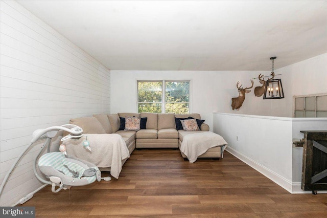 living room with wood finished floors and a notable chandelier