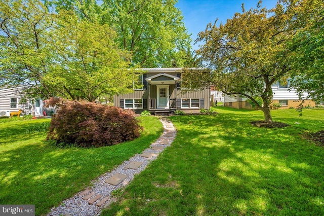view of front of home with board and batten siding and a front lawn