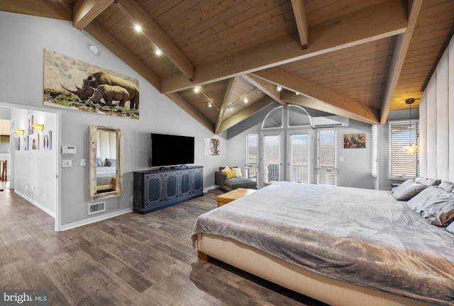 bedroom with visible vents, beamed ceiling, baseboards, and wood finished floors