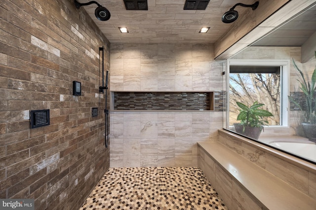 bathroom featuring visible vents and tiled shower