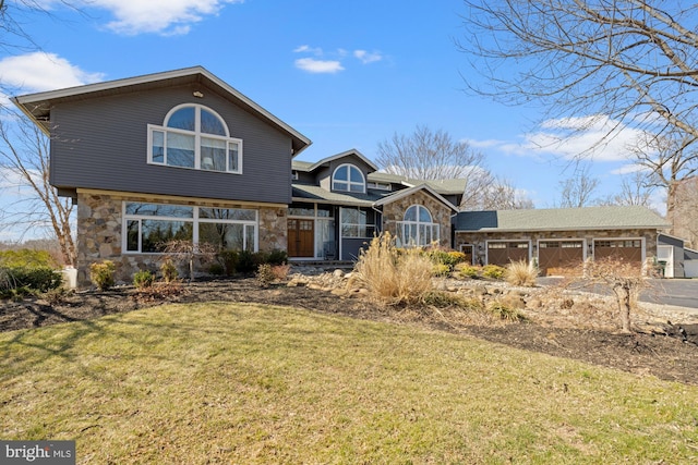 view of front of home with a front yard and stone siding