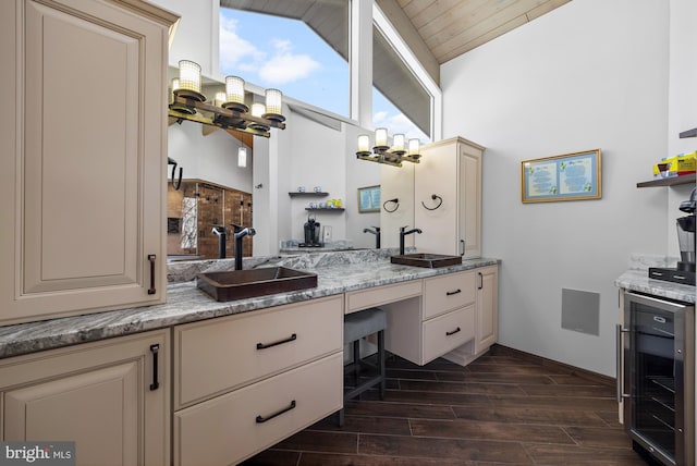 full bath featuring vaulted ceiling, wine cooler, wood tiled floor, and a sink