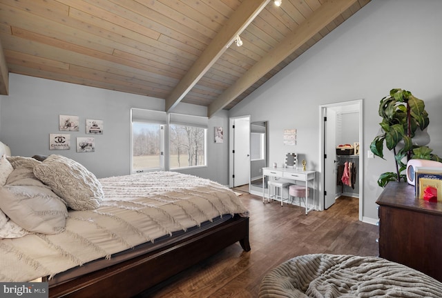 bedroom featuring wood finished floors, baseboards, vaulted ceiling with beams, a walk in closet, and wooden ceiling