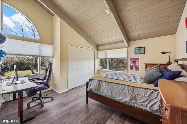 bedroom with track lighting, baseboards, lofted ceiling with beams, wooden ceiling, and wood finished floors