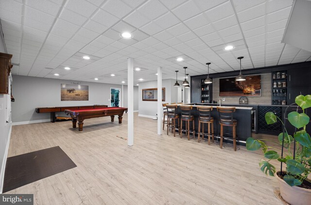 recreation room featuring a community bar, light wood-type flooring, billiards, and baseboards