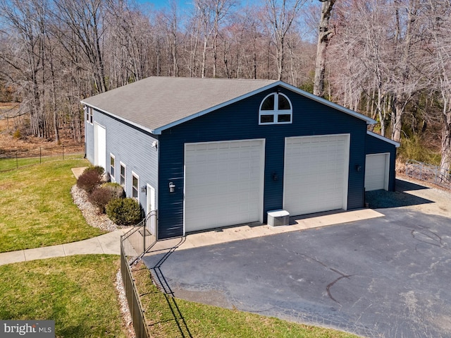 detached garage featuring fence