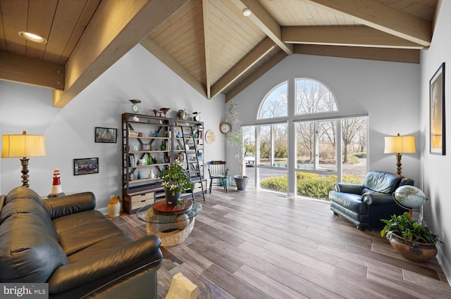 living room with beam ceiling, wooden ceiling, high vaulted ceiling, and wood finished floors