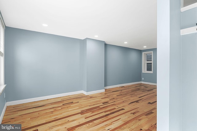 empty room with recessed lighting, baseboards, and light wood-style floors