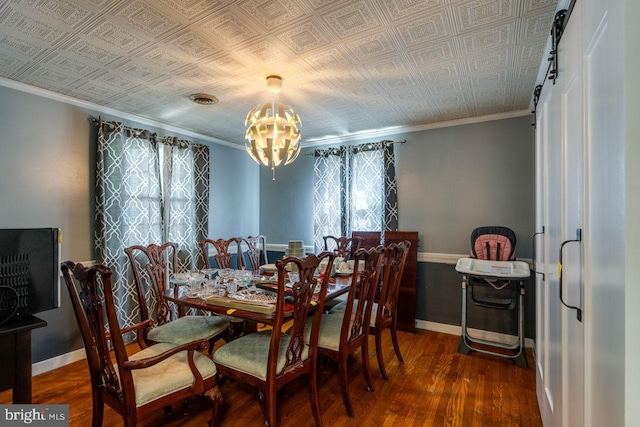 dining space with wood finished floors, baseboards, an ornate ceiling, and a chandelier