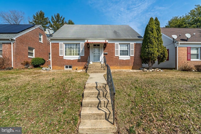 view of front of home featuring brick siding and a front yard