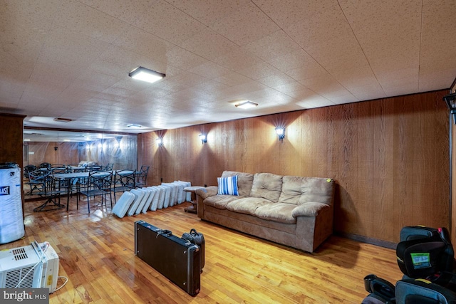 living room featuring wood walls and hardwood / wood-style flooring