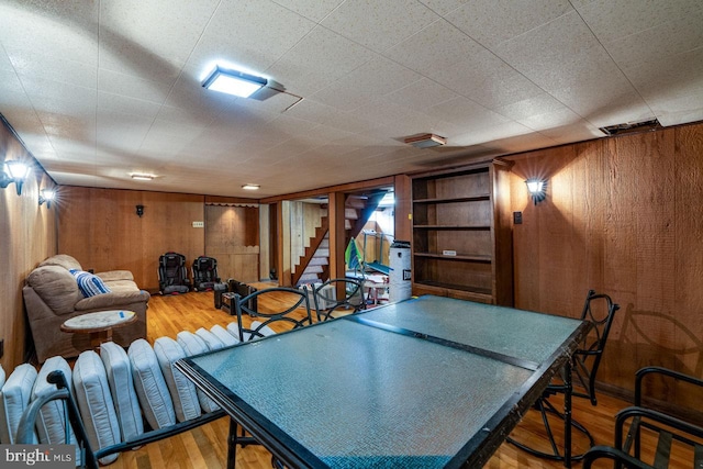 playroom featuring wooden walls and wood finished floors