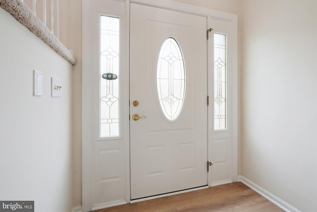 entrance foyer featuring baseboards and light wood-style floors