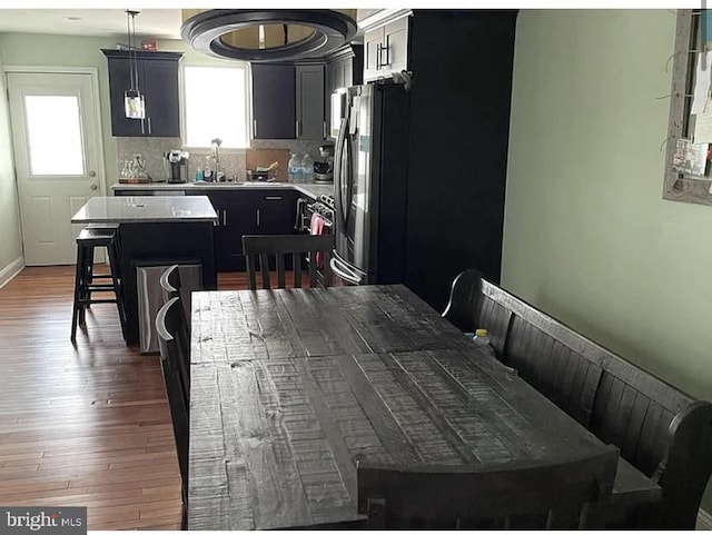 dining room with baseboards and wood finished floors