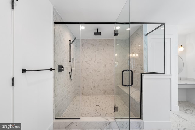 bathroom featuring recessed lighting, marble finish floor, and a shower stall