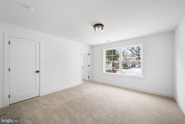 unfurnished bedroom with carpet and baseboards