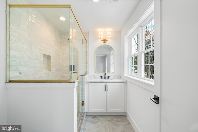 bathroom featuring a shower stall and vanity