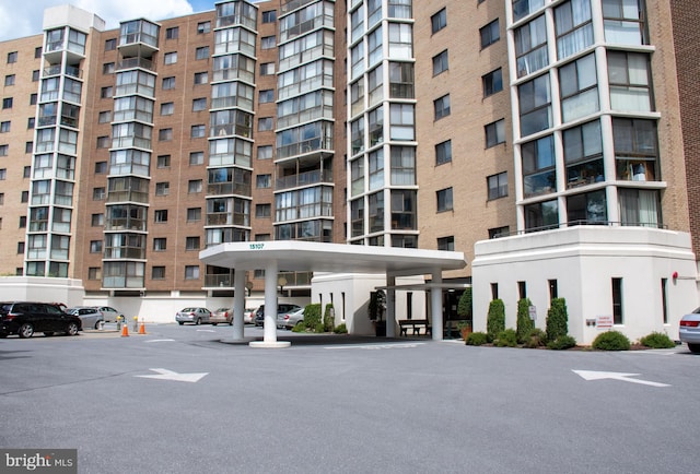 view of building exterior featuring uncovered parking