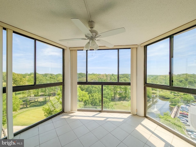 unfurnished sunroom featuring tile patterned flooring, floor to ceiling windows, and a textured ceiling