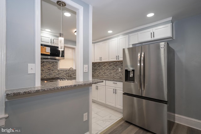 kitchen with marble finish floor, appliances with stainless steel finishes, white cabinetry, and dark stone countertops