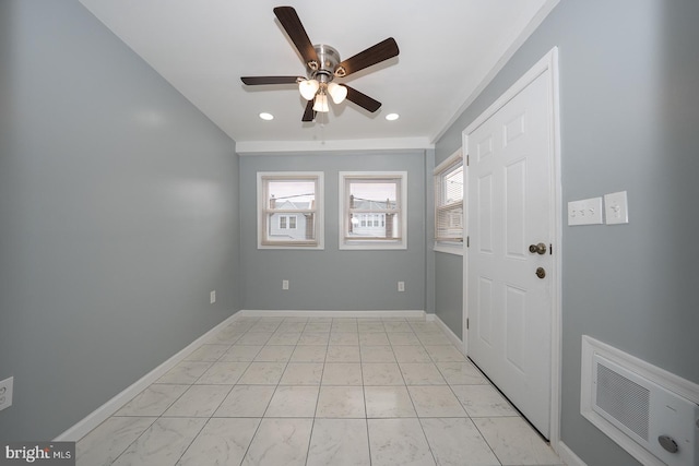 foyer entrance with visible vents, plenty of natural light, baseboards, and a ceiling fan