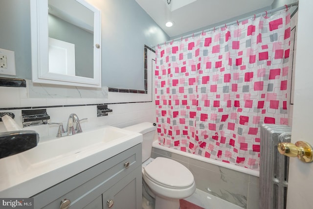 bathroom with toilet, radiator, tile walls, shower / tub combo, and vanity