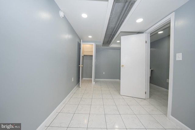 interior space featuring a spacious closet, recessed lighting, baseboards, and a closet