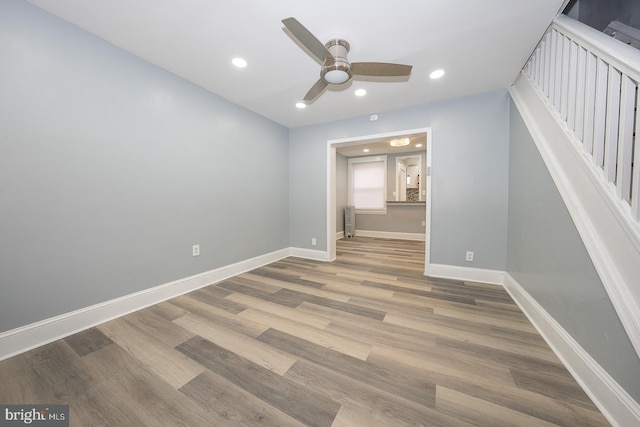 unfurnished bedroom with recessed lighting, baseboards, and wood finished floors