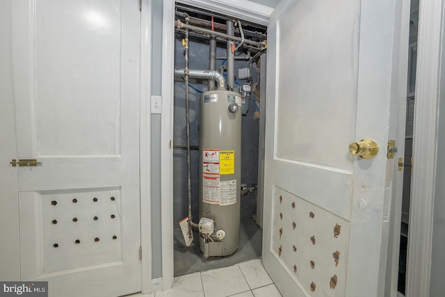 utility room featuring water heater