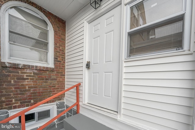 property entrance with brick siding