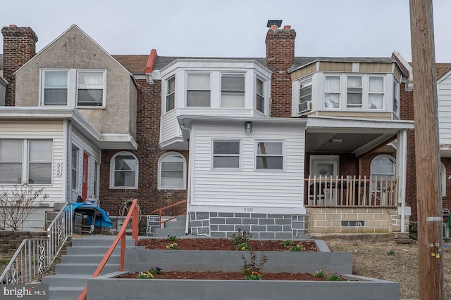 townhome / multi-family property featuring a porch