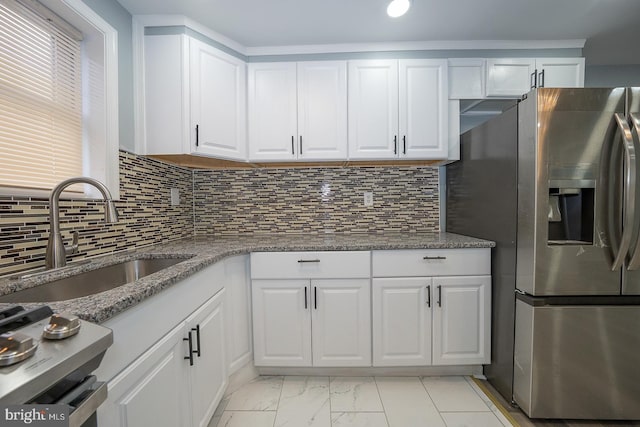 kitchen featuring a sink, marble finish floor, stainless steel fridge with ice dispenser, and white cabinetry