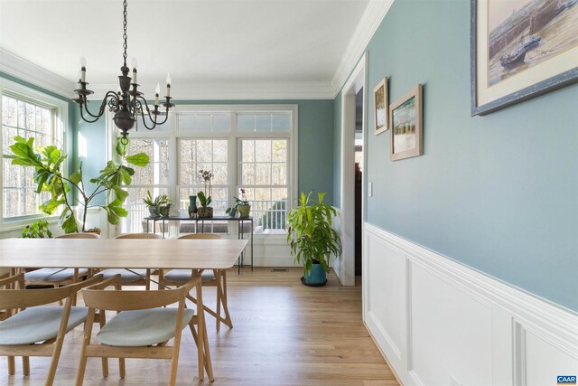 3535 Foxwood Dr, Barboursville, VA 22923 - dining space featuring a chandelier, ornamental molding, wainscoting, light wood-style floors, and a decorative wall