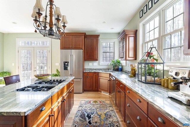 3535 Foxwood Dr, Barboursville, VA 22923 - kitchen with light wood-style flooring, a sink, stainless steel appliances, light stone countertops, and a chandelier