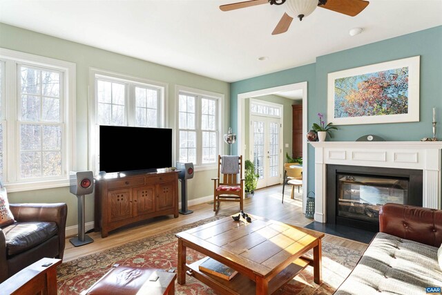 3535 Foxwood Dr, Barboursville, VA 22923 - living area with a fireplace with flush hearth, a ceiling fan, baseboards, and light wood finished floors