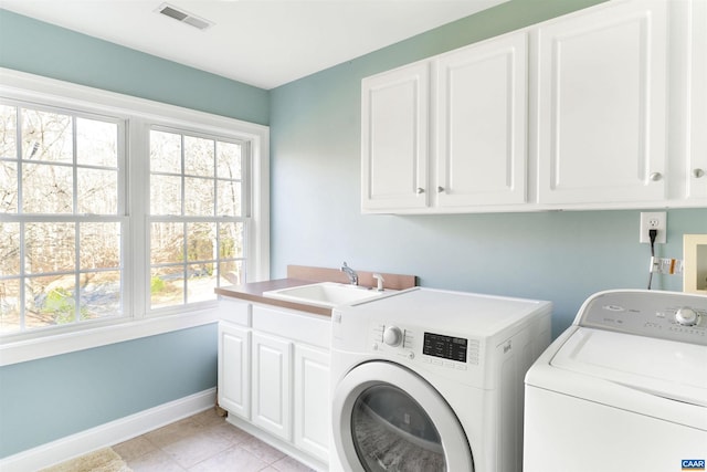 3535 Foxwood Dr, Barboursville, VA 22923 - laundry area featuring washing machine and clothes dryer, visible vents, a wealth of natural light, cabinet space, and a sink