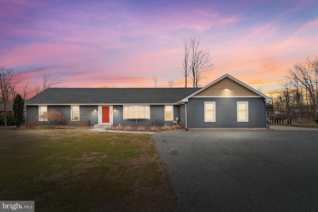 single story home with a front lawn and roof with shingles