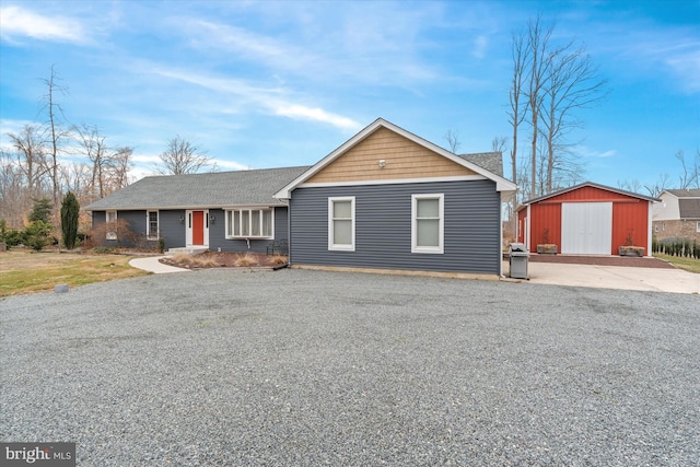 ranch-style home with an outbuilding and a storage shed