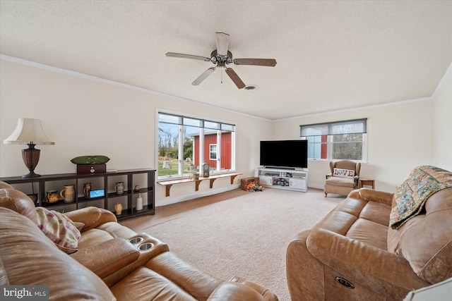 carpeted living room with a textured ceiling, crown molding, baseboards, and ceiling fan